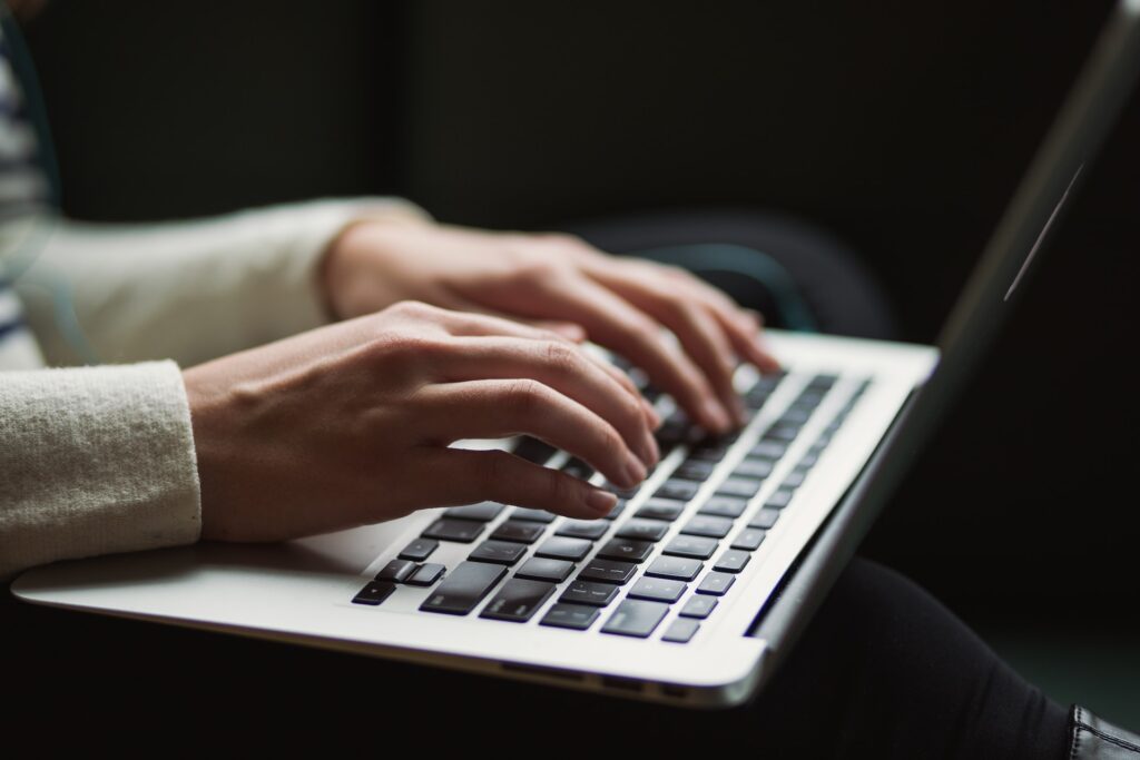 girl typing on laptop